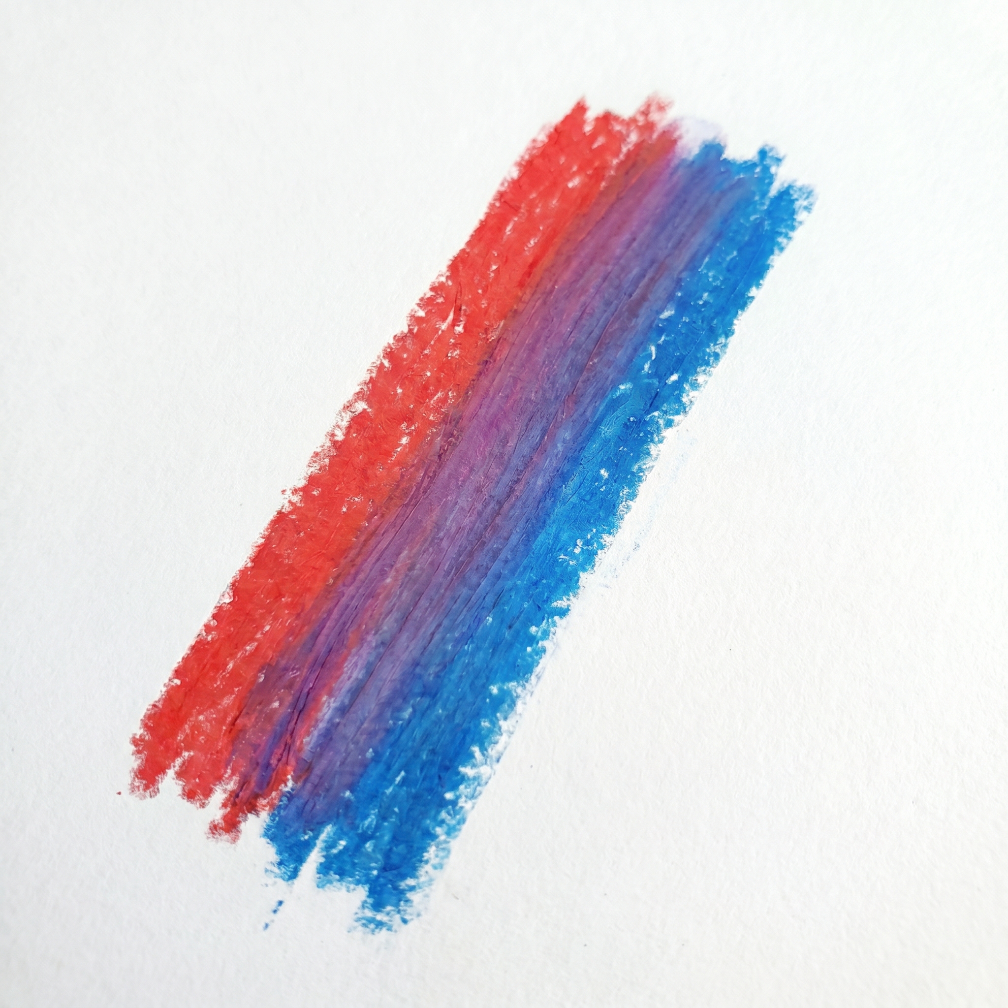 Wax pastel blending demonstration showing smooth gradients, layered colors, and soft shading effects on textured paper.